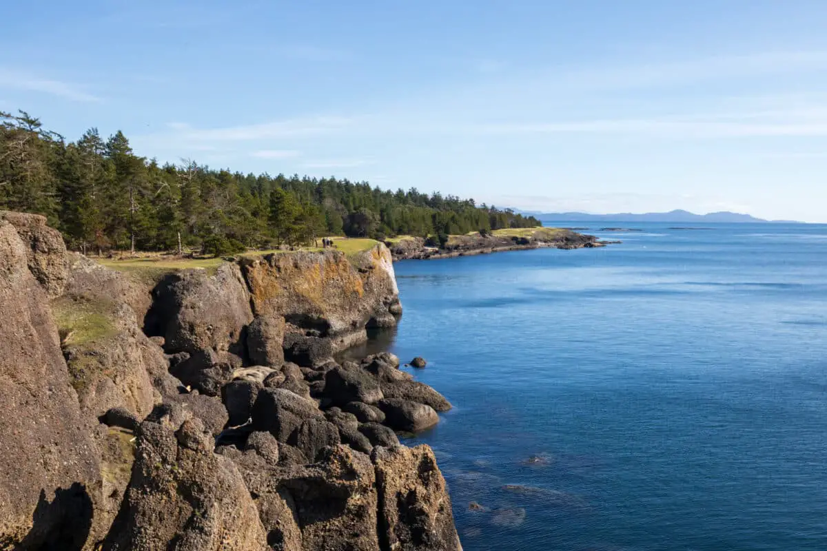 The ocean cliffs in Helliwell Provincial Park on Hornby Island, with distant mountains
