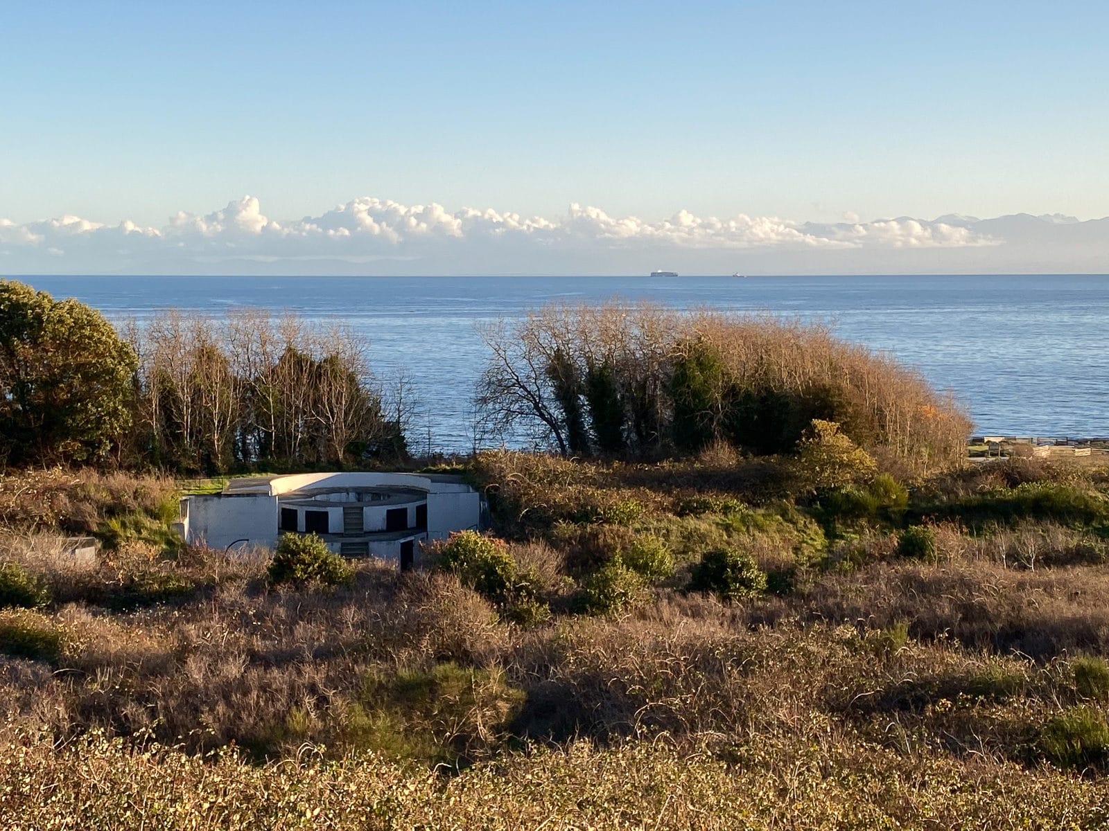 A Fort Macaulay gun emplacement at Macaulay Point Park with the mountains and ocean