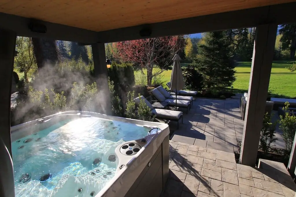 The hot tub steaming on the patio of the Northwood Chalet in Whistler
