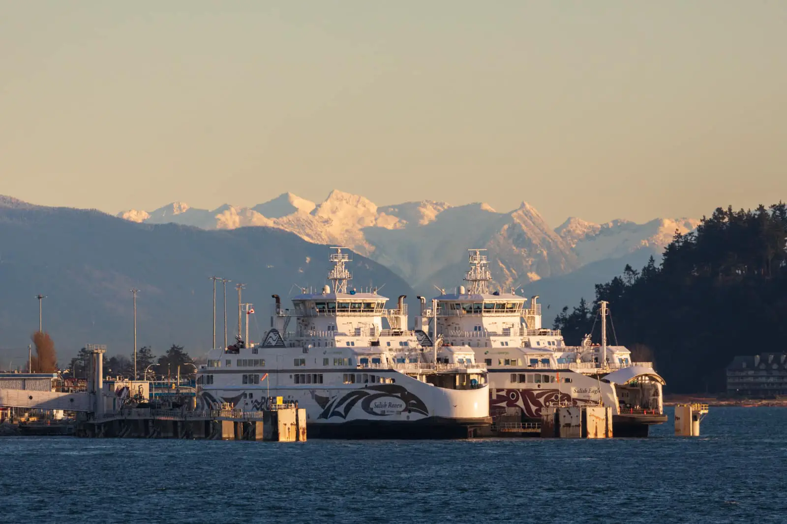 The Salish Eagle and Salish Raven docked at the Tsawwassen Ferry Terminal in Delta, Vancouver, with the mountains in the background