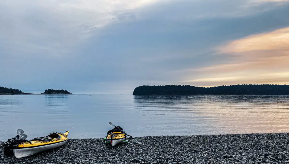 Two kayaks sitting beside the water at one of Nanaimo's best beaches, Departure Bay Beach