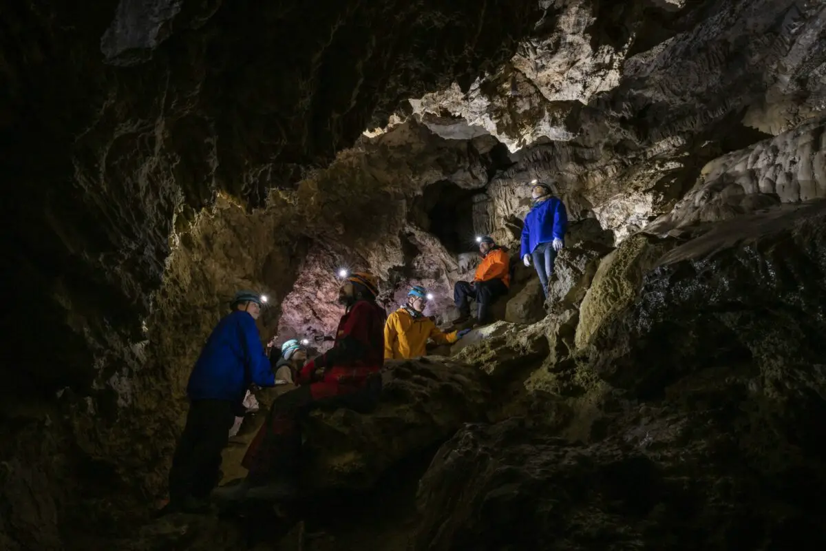 A group of people exploring the caves at Horne Lake Caves