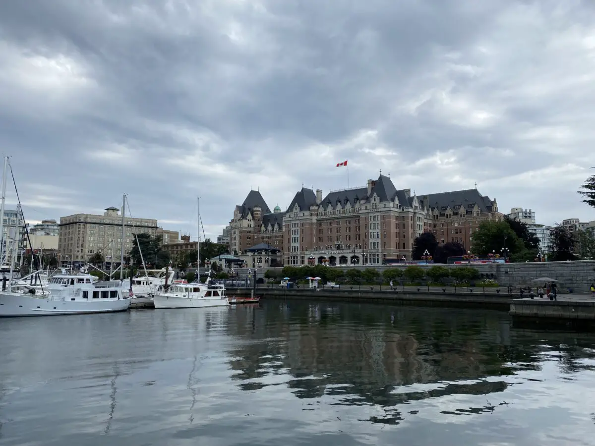 The boats in Victoria's Inner Harbour with the Empress Hotel in the background on a cloudy day