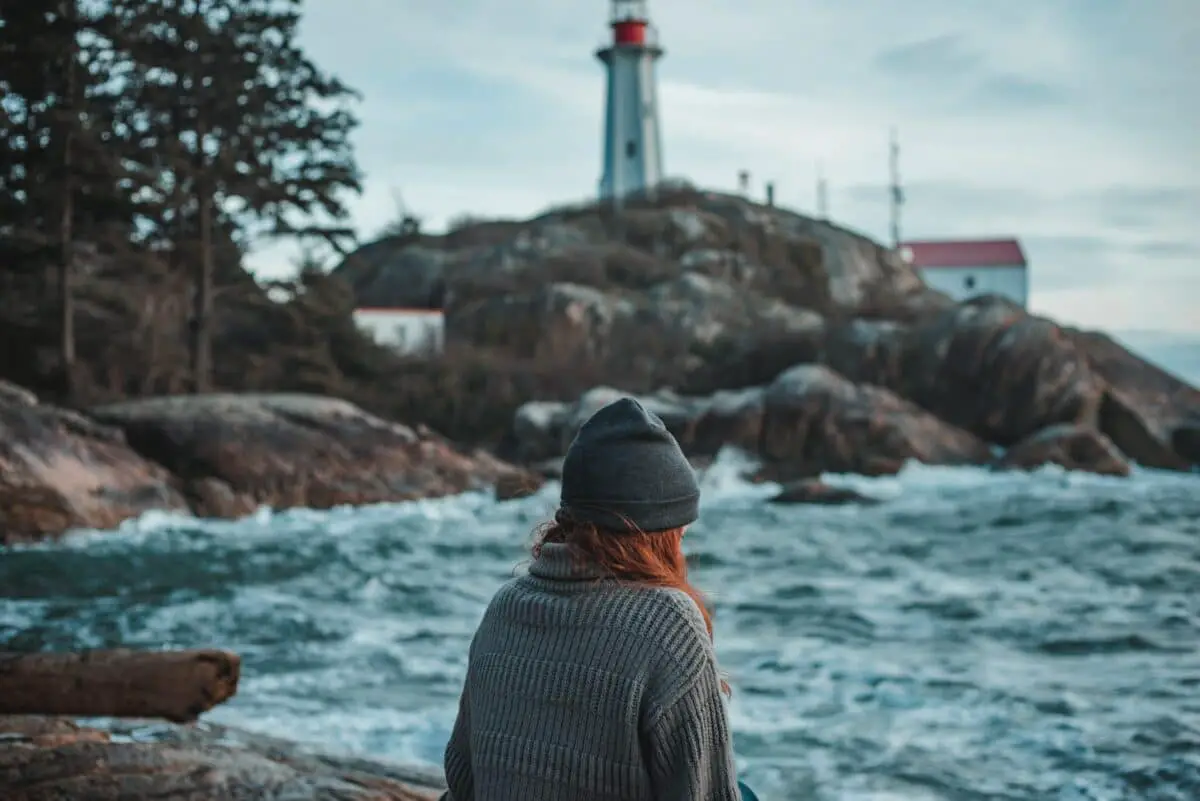 A person standing in front of lighthouse park in Vancouver