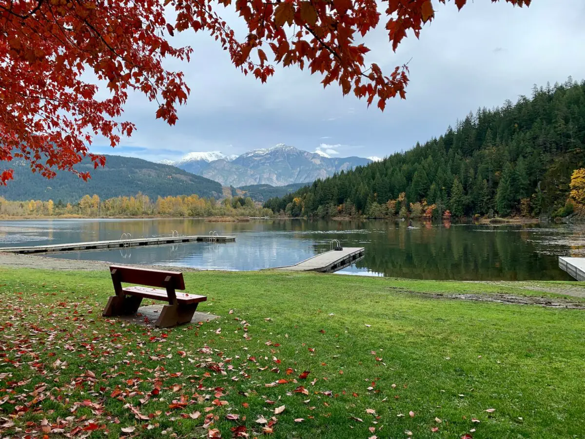 A bench sitting in front of One Mile Lake in Pemberton, BC