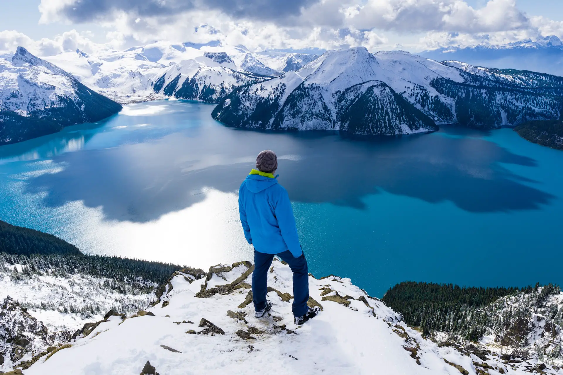A man looking out at Garibaldi Lake from Panorama Ridge in BC