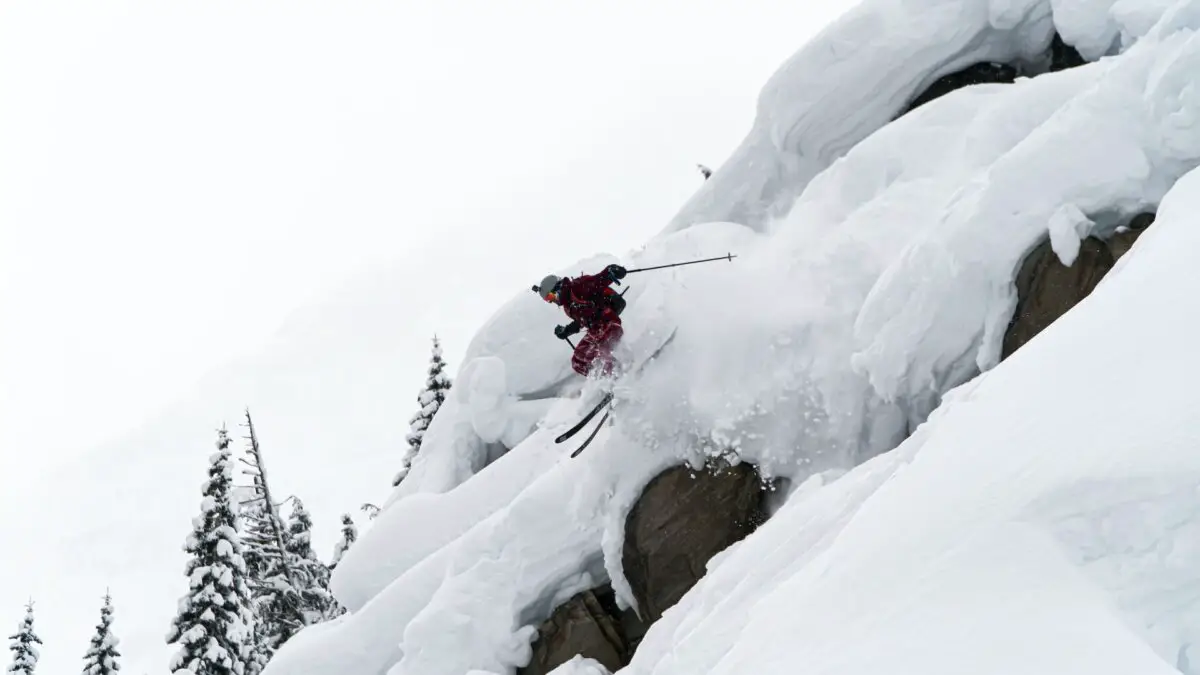 A skier jumping down the snowy slopes at Revelstoke Mountain Resort in the Kootenays