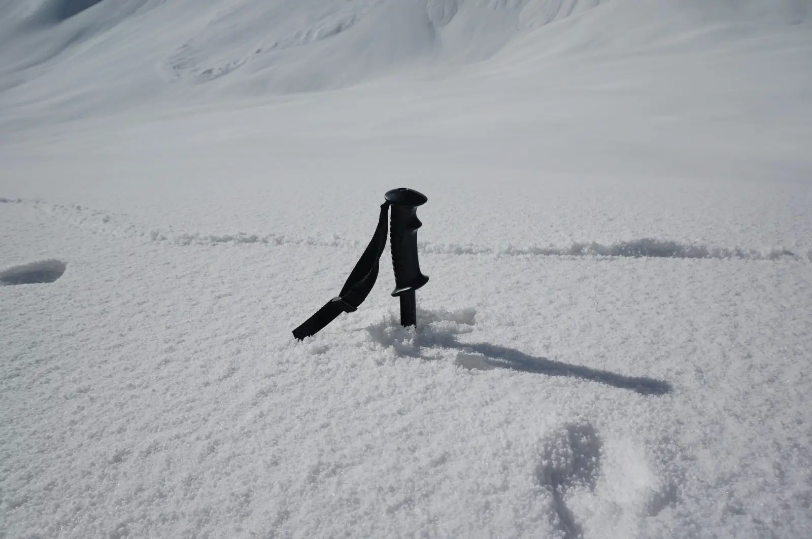 A trekking pole without a snow basket sunken deep into the snow - Photo: Andrew & Annemarie (CC)