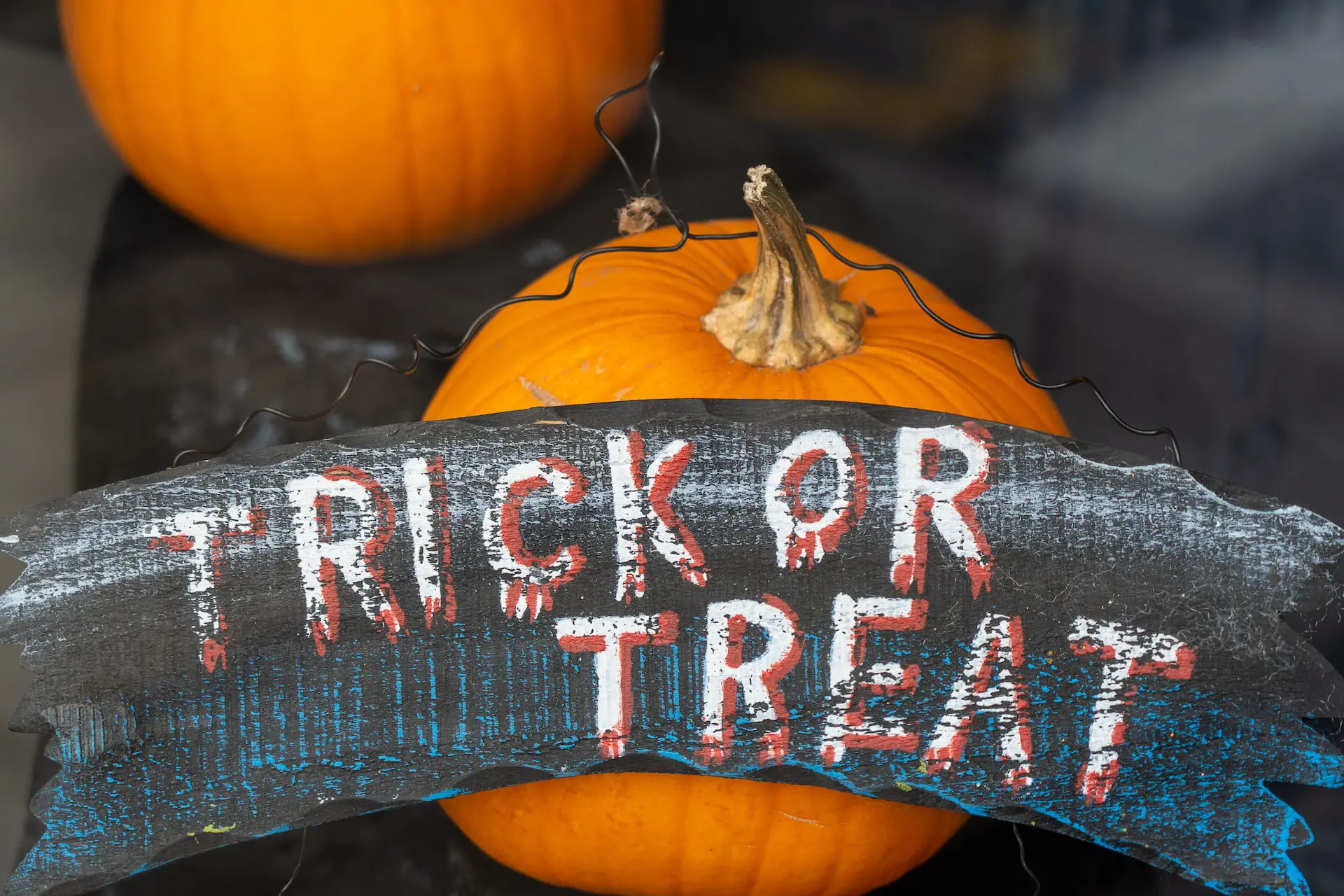 Trick or Treat sign over a pumpkin