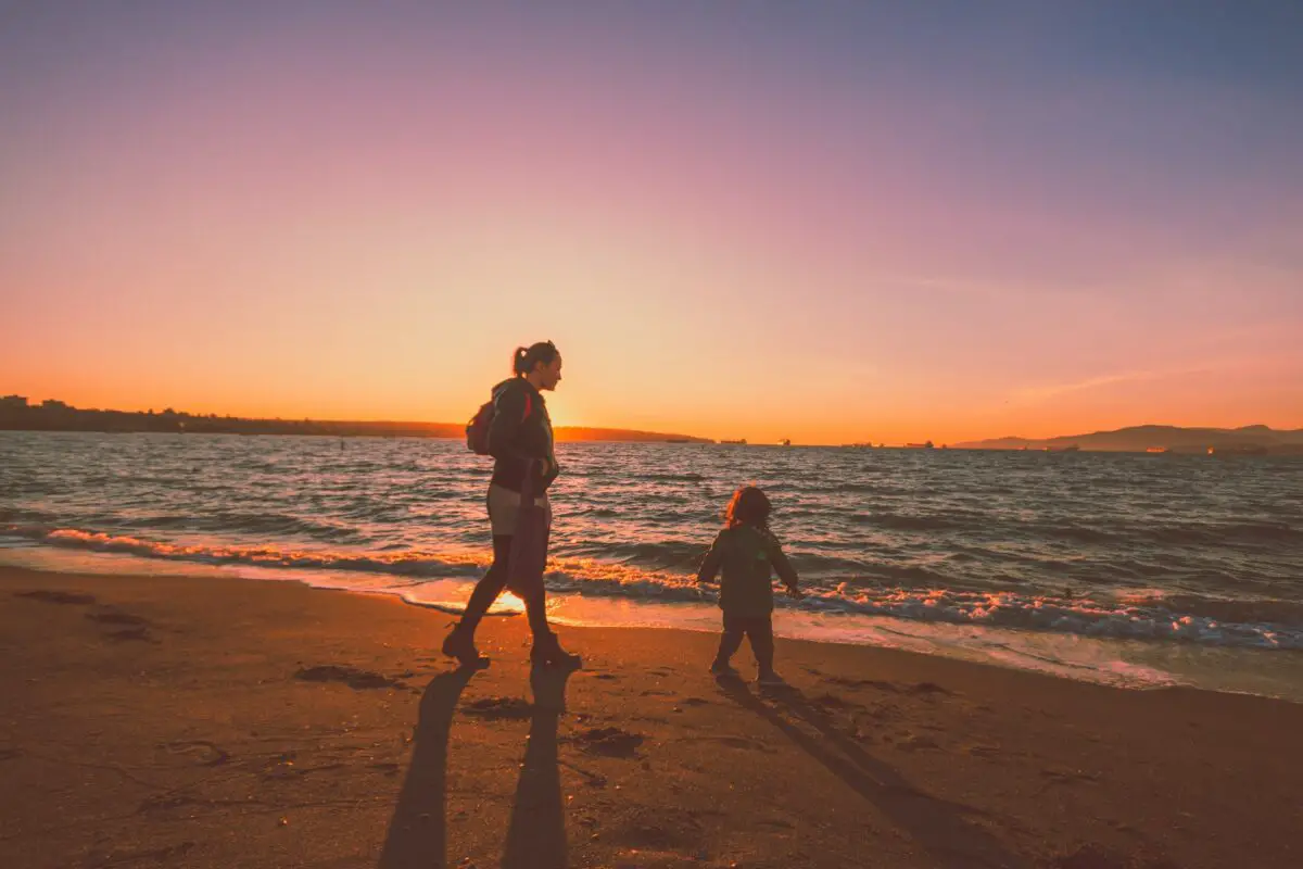 A mother and child on the beach at sunset in Vancouver